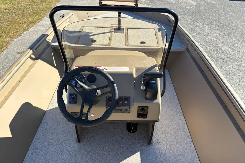 Slide: The Image of 2026 SeaArk Shadow 18 boat console with steering wheel and controls. - 13