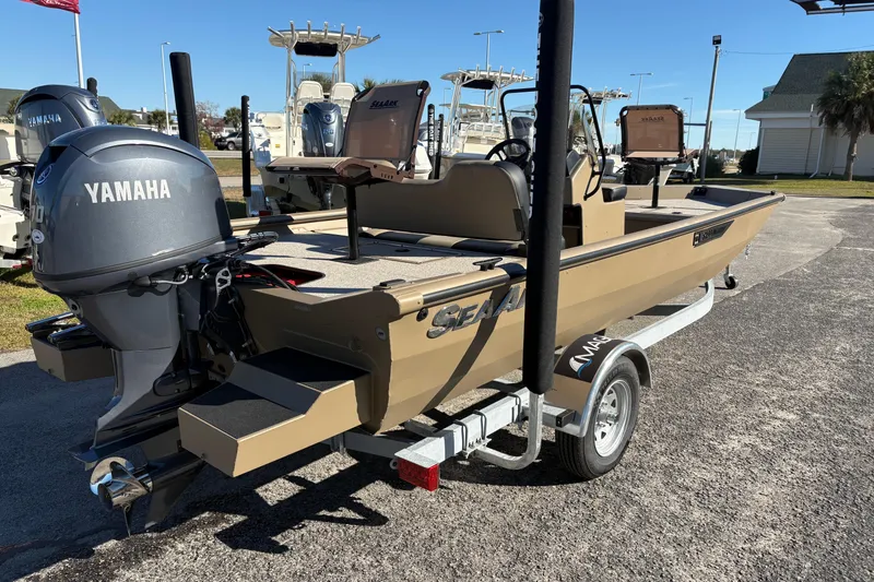 Slide: The Image of 2026 SeaArk Shadow 18 boat with Yamaha engine on a trailer, parked outdoors. - 4