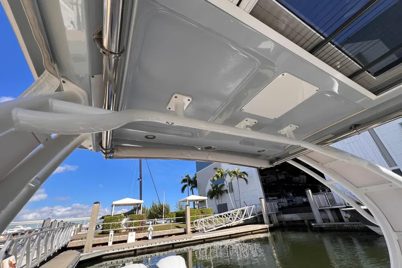 Slide: The Image of 2020 Chaparral 300 OSX boat canopy view at marina with clear blue sky. - 4