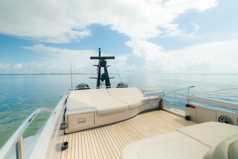 Slide: The Image of Luxurious 2021 Pershing 8X yacht deck with seating, overlooking calm ocean and clear sky. - 30