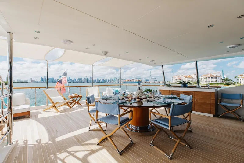 Slide: The Image of Luxurious 2018 Benetti Fast 125 yacht deck with elegant dining setup and stunning waterfront views. - 28