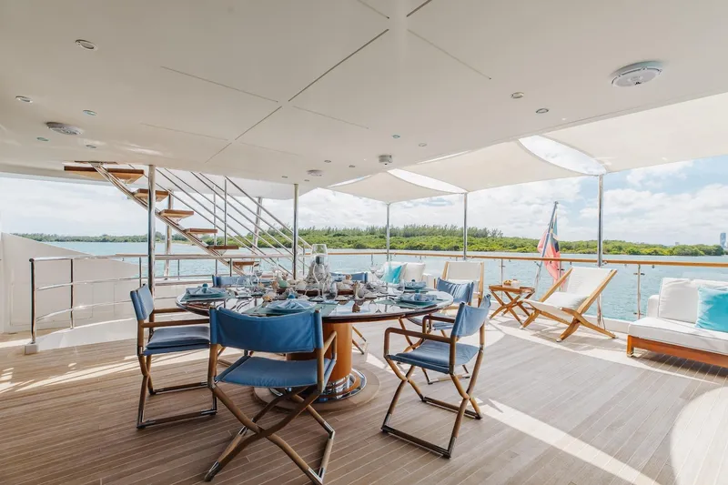 Slide: The Image of Luxurious 2018 Benetti Fast 125 yacht deck with elegant dining setup and scenic water views. - 29