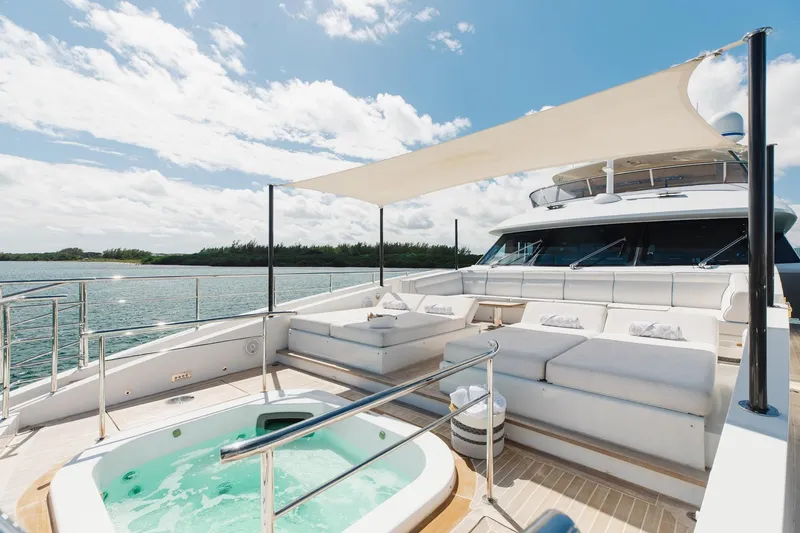 Slide: The Image of Luxurious 2018 Benetti Fast 125 yacht deck with jacuzzi and sunshade, overlooking serene waters. - 36
