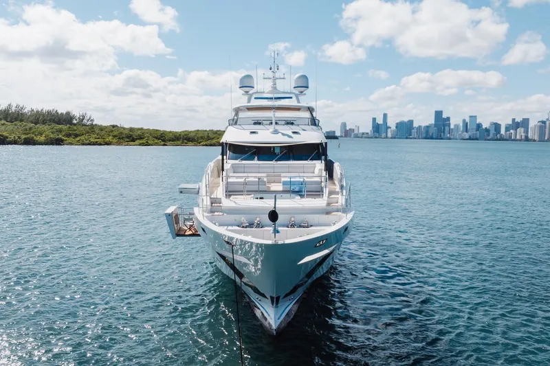 Slide: The Image of Luxurious 2018 Benetti Fast 125 yacht on serene water with city skyline backdrop. - 7