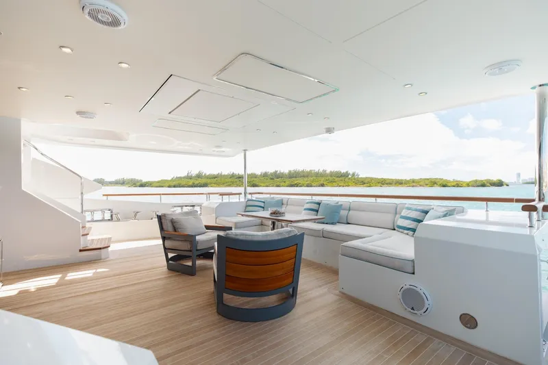 Slide: The Image of Luxurious 2018 Benetti Fast 125 yacht deck with elegant seating and scenic ocean view. - 9