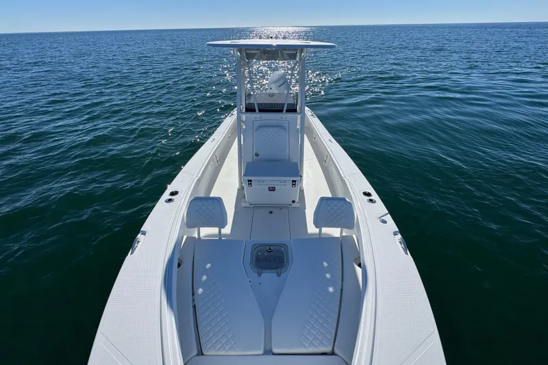 Slide: The Image of 2026 BlackJack 256 Coastal boat on open water, showcasing sleek design and spacious deck. - 16