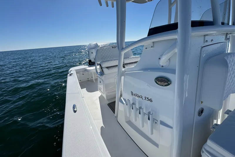 Slide: The Image of 2026 BlackJack 256 Coastal boat on open water, showcasing sleek design and spacious deck. - 19