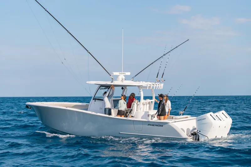 Slide: The Image of Phenom 34 Center Console 2026 on open sea with anglers. - 0