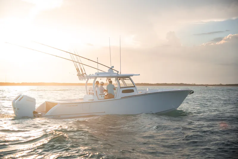 Slide: The Image of Phenom 34 Center Console 2026 on water at sunset. - 1