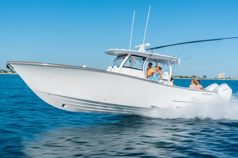 Slide: The Image of Phenom 34 Center Console 2026 on water with passengers. - 2