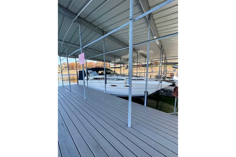 The Image of 1986 Sea-Ray 340 Express docked under covered marina. - 0