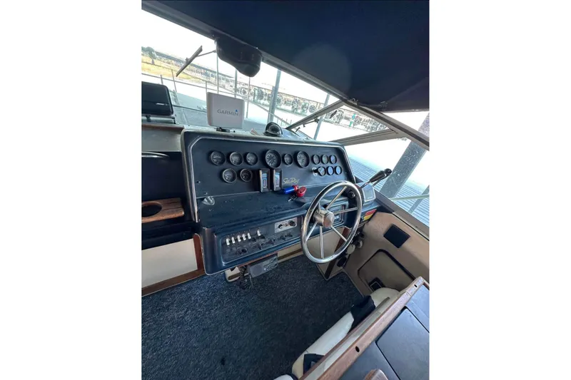 Slide: The Image of 1986 Sea-Ray 340 Express boat dashboard with steering wheel and gauges. - 10