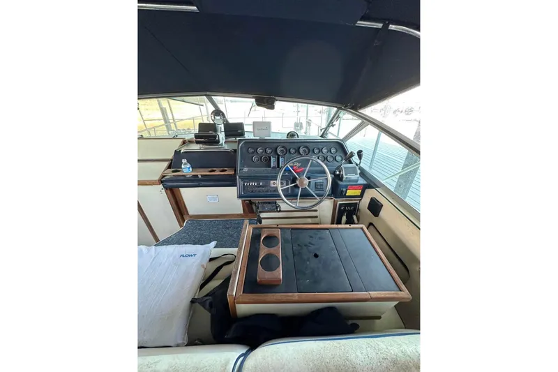 Slide: The Image of 1986 Sea-Ray 340 Express boat cockpit with steering wheel and control panel. - 14
