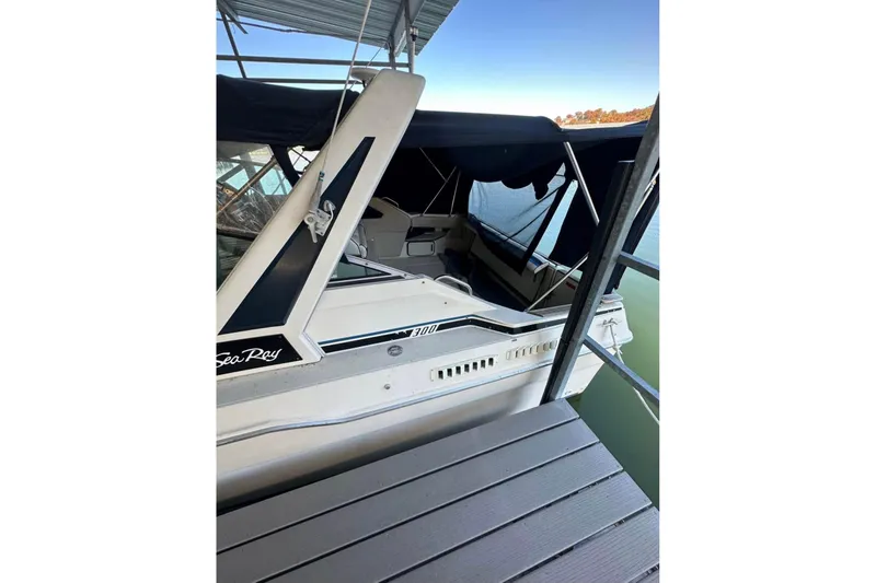 Slide: The Image of 1986 Sea-Ray 340 Express boat docked under a canopy. - 15