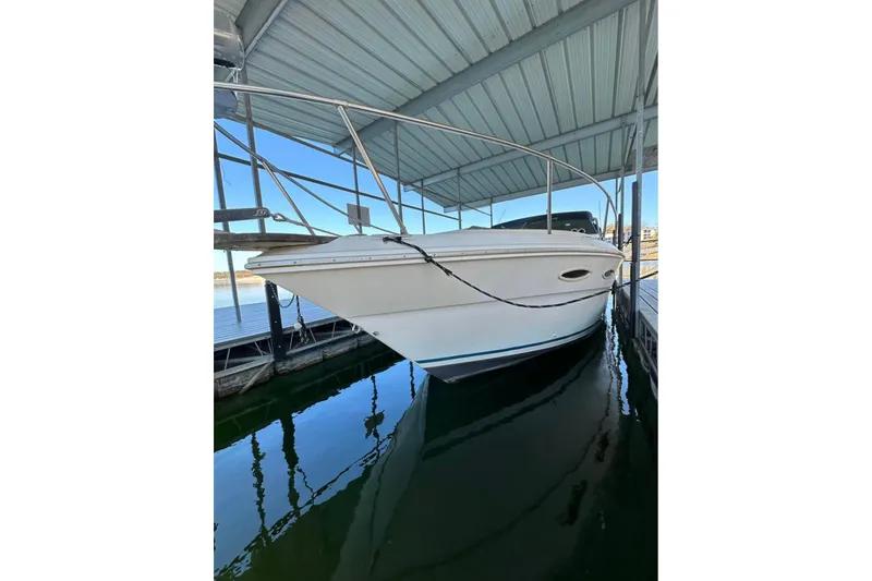 Slide: The Image of 1986 Sea-Ray 340 Express boat docked under a covered marina. - 16