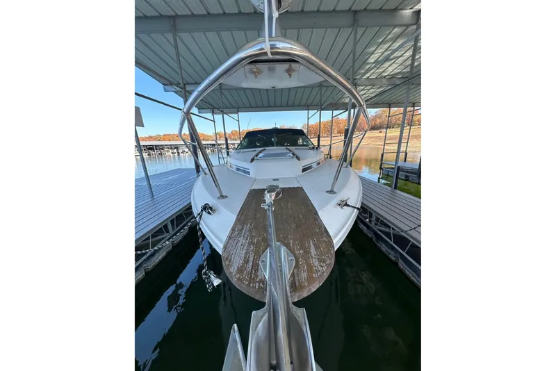 Slide: The Image of 1986 Sea-Ray 340 Express docked under a covered marina. - 2