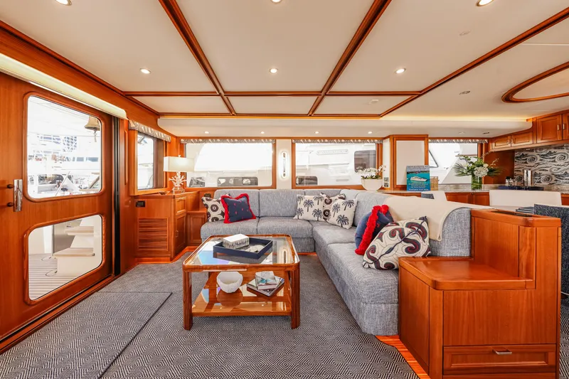 Slide: The Image of Luxurious interior of 2027 Fleming 85 Pilothouse yacht with elegant wood finishes and plush seating. - 10