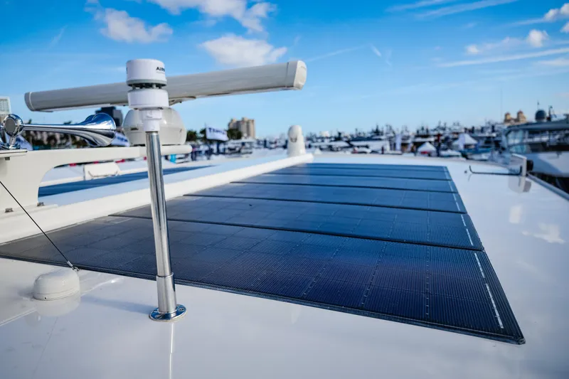 Slide: The Image of Fleming 85 Pilothouse 2027 yacht with solar panels on deck, marina background. - 105