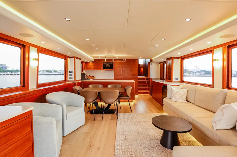 Slide: The Image of Luxurious interior of 2027 Fleming 85 Pilothouse yacht with modern furnishings and large windows. - 12