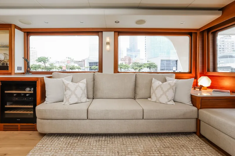 Slide: The Image of Luxurious interior of 2027 Fleming 85 Pilothouse yacht with elegant sofa and large windows. - 13