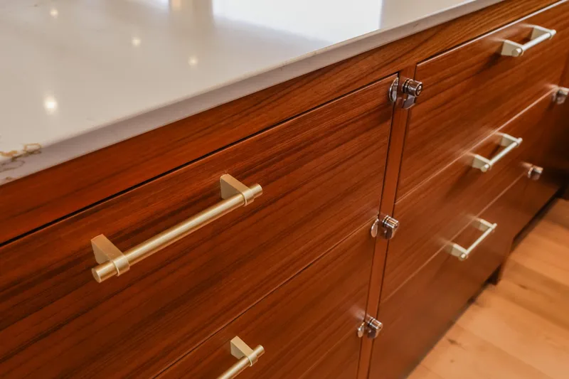 Slide: The Image of Wooden cabinetry with sleek metal handles in a 2027 Fleming 85 Pilothouse yacht. - 18