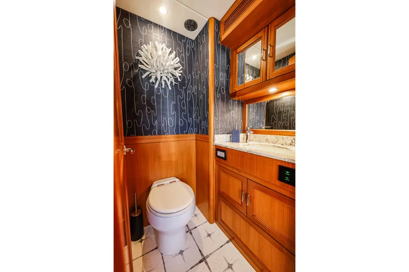 Slide: The Image of Luxurious bathroom in 2027 Fleming 85 Pilothouse yacht with elegant wood cabinetry and modern decor. - 19