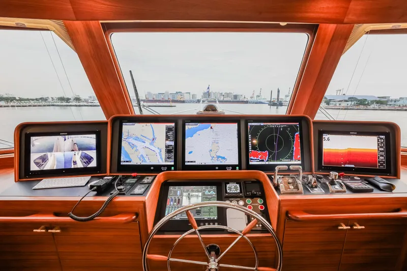 Slide: The Image of Pilothouse of 2027 Fleming 85 yacht with advanced navigation displays and controls. - 22