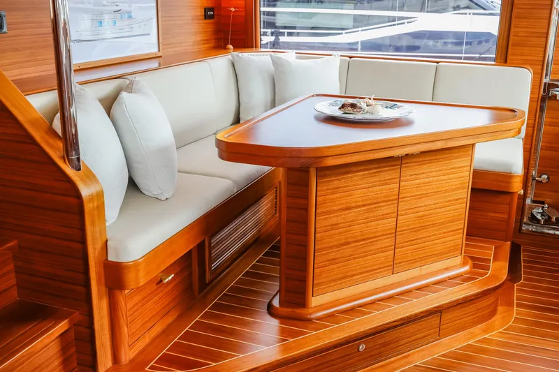 Slide: The Image of Luxurious interior of 2027 Fleming 85 Pilothouse yacht with elegant wood finish and cozy seating. - 25
