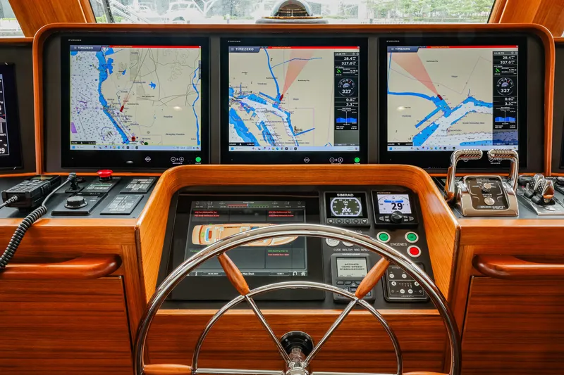 Slide: The Image of Pilothouse of 2027 Fleming 85 yacht with advanced navigation displays and controls. - 26