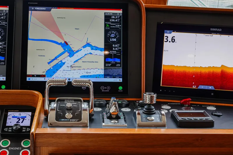 Slide: The Image of Pilothouse dashboard of 2027 Fleming 85, featuring navigation and control systems. - 28
