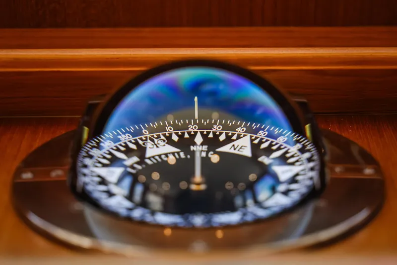 Slide: The Image of Compass on Fleming 85 Pilothouse yacht, 2027 model, with wooden background. - 33