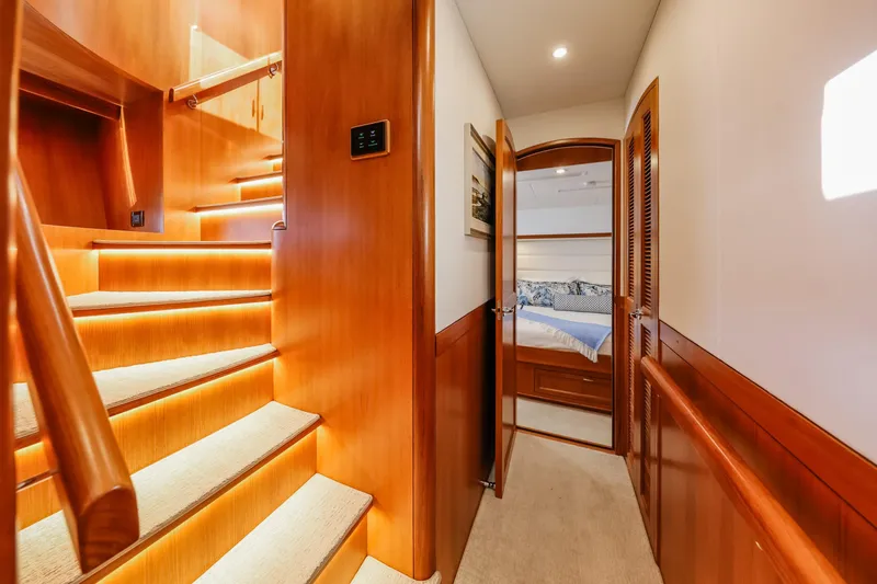 Slide: The Image of Luxurious interior of 2027 Fleming 85 Pilothouse yacht with elegant wooden staircase and cozy bedroom. - 36