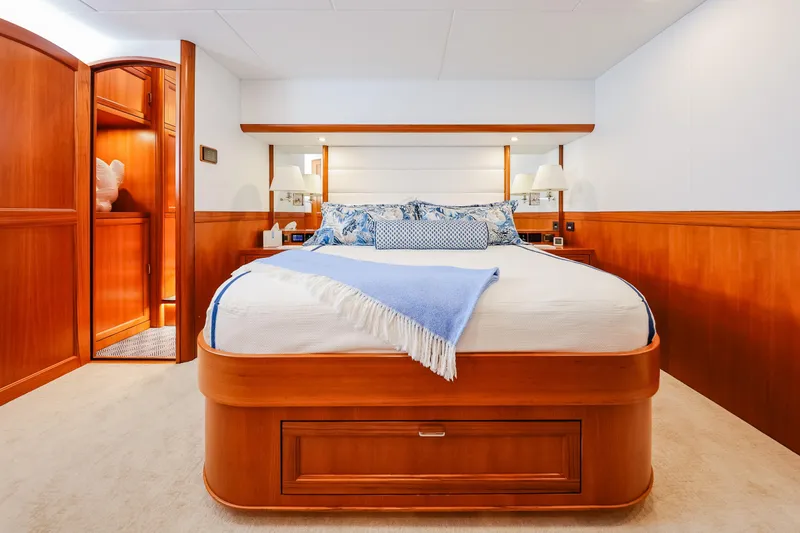 Slide: The Image of Luxurious bedroom in 2027 Fleming 85 Pilothouse yacht with elegant wood finishes. - 37