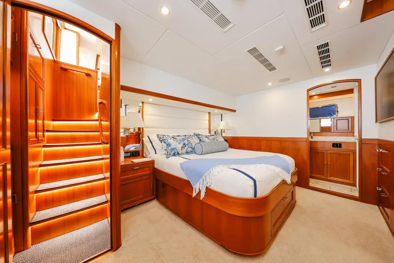 Slide: The Image of Luxurious bedroom interior of 2027 Fleming 85 Pilothouse yacht with elegant wood finishes. - 38