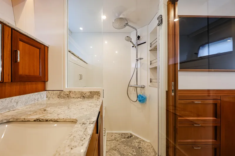 Slide: The Image of Luxurious bathroom in 2027 Fleming 85 Pilothouse yacht with modern shower and elegant wood cabinetry. - 45