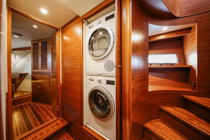 Slide: The Image of Luxurious 2027 Fleming 85 Pilothouse interior with wood finish and stacked washer-dryer. - 58