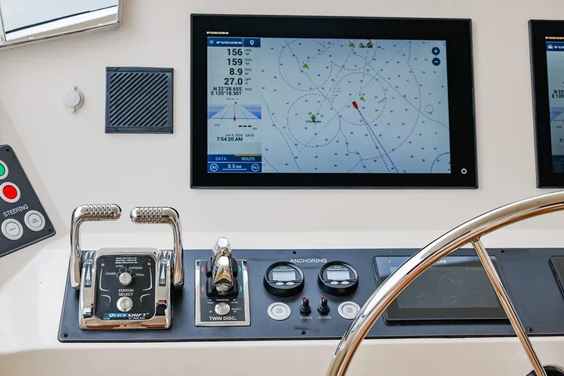 Slide: The Image of Control panel of 2027 Fleming 85 Pilothouse yacht with navigation display and steering wheel. - 64