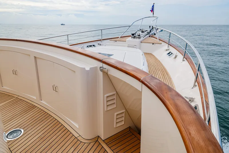 Slide: The Image of Luxurious 2027 Fleming 85 Pilothouse yacht deck with elegant wood finish, cruising on open sea. - 71