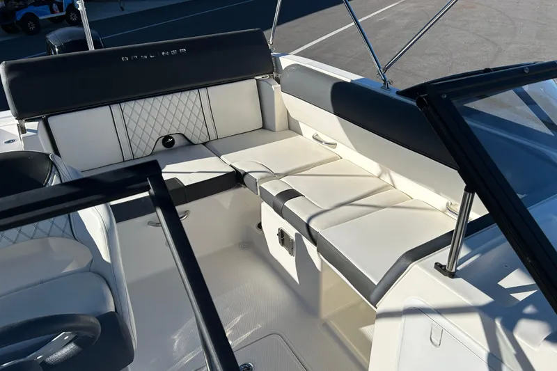Slide: The Image of 2021 Bayliner DX 2000 boat interior with white seating and black accents. - 11