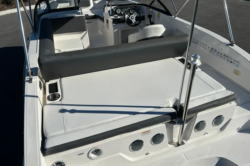 Slide: The Image of 2021 Bayliner DX 2000 boat interior with seating and steering wheel. - 14