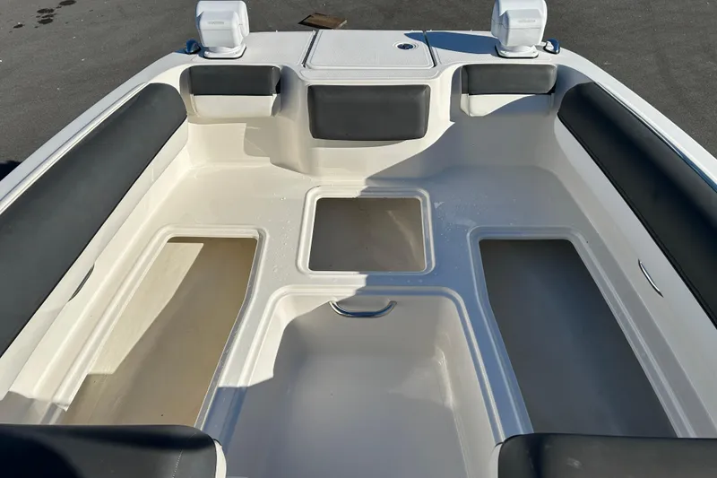 Slide: The Image of 2021 Bayliner DX 2000 boat interior with spacious seating and storage compartments. - 15