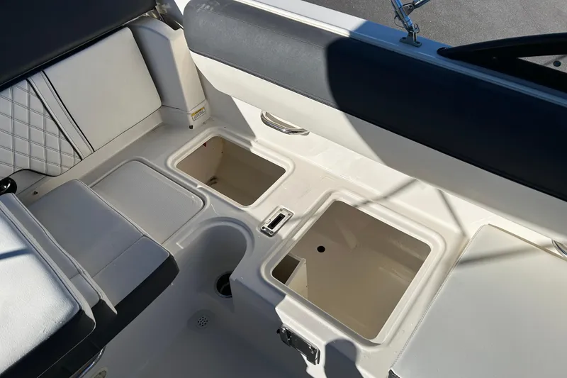 Slide: The Image of 2021 Bayliner DX 2000 boat interior with storage compartments and seating. - 17