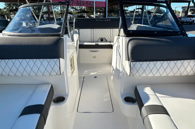 Slide: The Image of 2021 Bayliner DX 2000 boat interior with cushioned seating and cup holders. - 9
