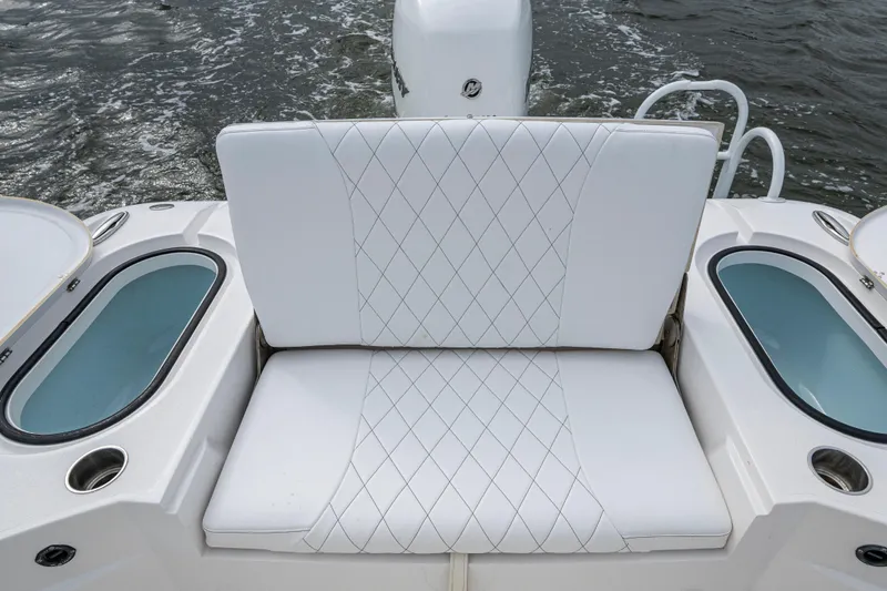 Slide: The Image of 2022 Blazer Bay 2700 Hybrid boat seat with diamond-stitched upholstery and livewell compartments. - 10