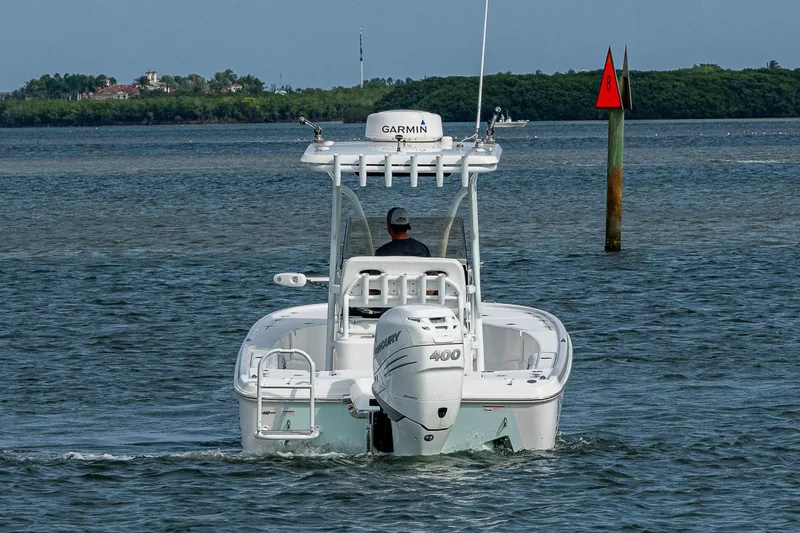 Slide: The Image of 2022 Blazer Bay 2700 Hybrid boat cruising on open water. - 13