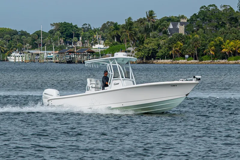 Slide: The Image of 2022 Blazer Bay 2700 Hybrid boat cruising on a scenic waterway. - 15