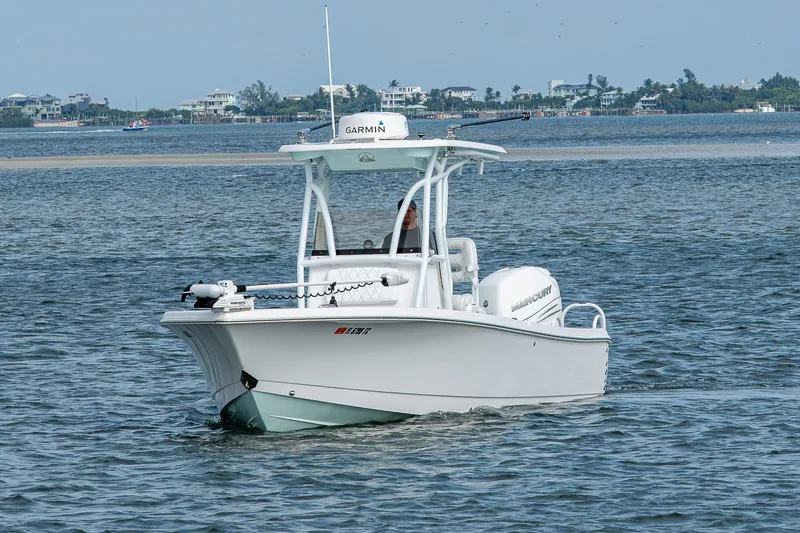 Slide: The Image of 2022 Blazer Bay 2700 Hybrid boat cruising on open water. - 17