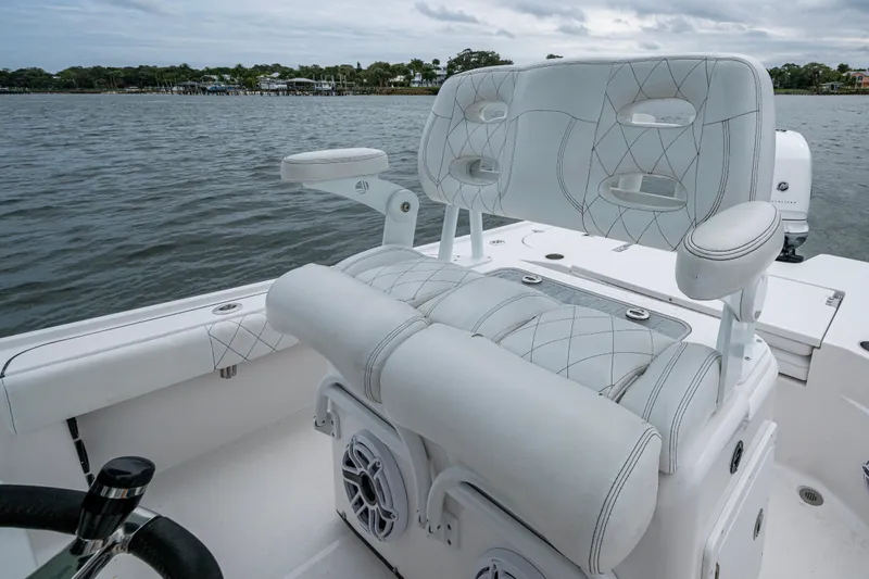 Slide: The Image of 2022 Blazer Bay 2700 Hybrid boat with luxurious seating on a calm water backdrop. - 4