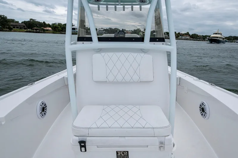 Slide: The Image of 2022 Blazer Bay 2700 Hybrid boat interior with white seating and water view. - 6