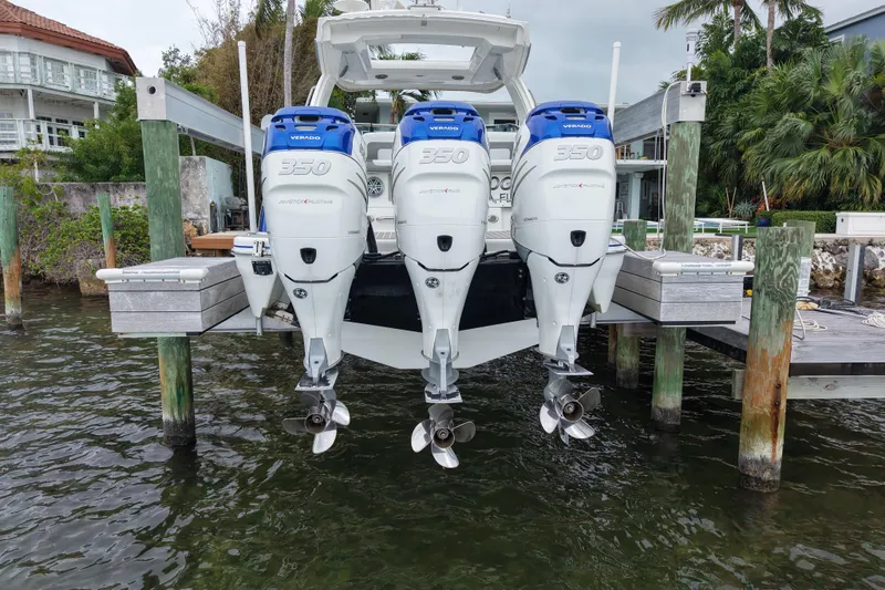 Slide: The Image of 2018 Formula 350 FX Crossover Bowrider with triple outboard engines docked. - 10